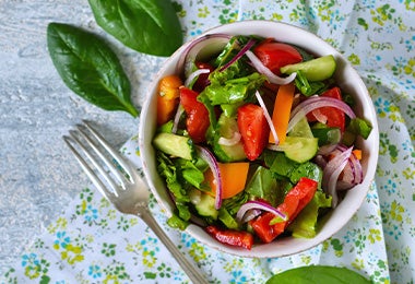 Ensalada con base de hojas verdes, con zanahoria y cebolla, una comida fácil de hacer. 