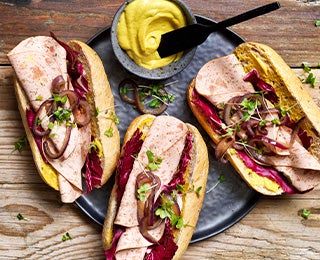 Montaditos de pan baguette con embutidos, cebolla caramelizada y mostaza