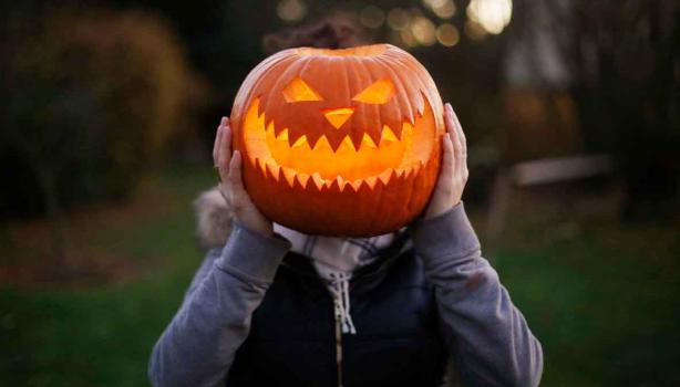 Calabaza de Halloween sobre el cuerpo de una persona. 