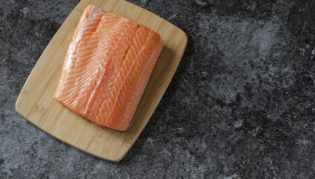Filete de salmón fresco sobre tabla de madera