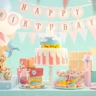Celebración de cumpleaños con variedad de postres en una mesa de dulces