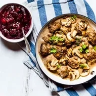 Carne en salsa de champiñones y perejil en una sartén