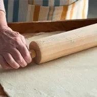 Persona estirando masa con rodillo de cocina