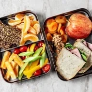 Envase de meal prep con frutas y vegetales.