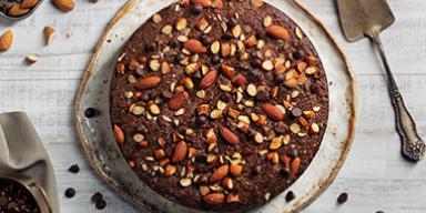 Torta de chocolate decorada con almendras sin pelar enteras y trituradas Torta de chocolate decorada con almendras sin pelar enteras y trituradas
